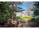 Landscaped backyard featuring a bird bath and a border of decorative rocks at 13183 Spica Dr, Lone Tree, CO 80124