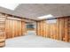 Finished basement with wood paneling and neutral carpet at 13183 Spica Dr, Lone Tree, CO 80124