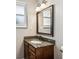 Bathroom vanity with granite countertop, decorative mirror and sconce lighting at 13183 Spica Dr, Lone Tree, CO 80124