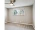 Bedroom featuring neutral walls, carpet, ceiling fan with light, and bright window for natural light at 13183 Spica Dr, Lone Tree, CO 80124