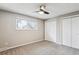 Bedroom featuring neutral walls, carpet, ceiling fan with light, and bright window for natural light at 13183 Spica Dr, Lone Tree, CO 80124