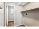 A functional laundry area with shelving and access to an adjacent room at 13183 Spica Dr, Lone Tree, CO 80124