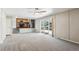 Open-concept living room with a view of the adjacent kitchen and a sliding glass door to the backyard at 13183 Spica Dr, Lone Tree, CO 80124