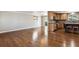 Open concept living area with hardwood floors seamlessly flowing into the kitchen and dining space at 13183 Spica Dr, Lone Tree, CO 80124