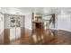 Open-concept living area featuring hardwood floors, sliding glass doors, and seamless flow to the kitchen at 13183 Spica Dr, Lone Tree, CO 80124