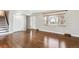 Inviting living room featuring gleaming hardwood floors, a large window, and ample natural light at 13183 Spica Dr, Lone Tree, CO 80124