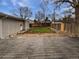 This backyard features a wooden deck, a small grassy area, and a rock garden, all surrounded by a wooden fence at 2900 S Downing St, Englewood, CO 80113