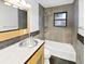 Sleek bathroom with modern fixtures, a stylish mirror, and a tiled shower/tub combo at 2900 S Downing St, Englewood, CO 80113