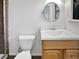 A partial bathroom featuring a wood cabinet vanity, white countertop, modern faucet, and tile flooring at 2900 S Downing St, Englewood, CO 80113