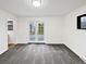 A bedroom with a walkout to the backyard, carpet flooring, neutral walls, and an open entry to another room at 2900 S Downing St, Englewood, CO 80113