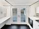 Laundry room with exterior access, white cabinets, and modern washer and dryer at 2900 S Downing St, Englewood, CO 80113