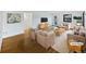 Bright, staged living room featuring hardwood floors and neutral furnishings at 2900 S Downing St, Englewood, CO 80113
