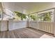 Charming, covered back porch with white railing and a great private outdoor seating area at 13940 E Linvale Pl, Aurora, CO 80014