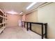 Unfinished basement with workbench, shelving, and great potential for storage or customization at 13940 E Linvale Pl, Aurora, CO 80014