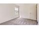This is a cozy bedroom with carpet, natural light, and a standard-size door at 13940 E Linvale Pl, Aurora, CO 80014