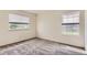 This bright bedroom has carpet and large windows providing natural light and exterior views at 13940 E Linvale Pl, Aurora, CO 80014