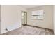 This is a well-lit bedroom with a sliding door closet, carpet, and a large window at 13940 E Linvale Pl, Aurora, CO 80014