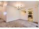 Carpeted dining room with view into the kitchen at 13940 E Linvale Pl, Aurora, CO 80014