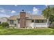 Residential home exterior with a brick chimney, well-maintained lawn, and traditional siding at 13940 E Linvale Pl, Aurora, CO 80014