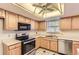 Functional kitchen with stainless steel appliances and tile flooring at 13940 E Linvale Pl, Aurora, CO 80014
