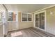 Covered outdoor patio with wooden deck, sliding door access, and enclosed railing at 13940 E Linvale Pl, Aurora, CO 80014