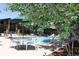 Outdoor swimming pool with lounge chairs and umbrellas, perfect for relaxation and recreation at 13940 E Linvale Pl, Aurora, CO 80014