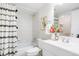 Bathroom with a shower-tub combo and a stylish shower curtain at 3452 S Eagle St # 101, Aurora, CO 80014