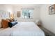 Bright bedroom featuring a tufted headboard and a comfortable chair near the window at 3452 S Eagle St # 101, Aurora, CO 80014