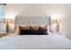 Bedroom showcases a plush bed with stylish lamps on either side at 3452 S Eagle St # 101, Aurora, CO 80014