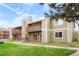 Charming condo complex featuring private balconies, stone accents, and lush landscaping at 3452 S Eagle St # 101, Aurora, CO 80014