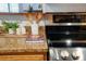 Granite kitchen counter with stainless steel stove and cooktop, and tastefully arranged decorative items at 3452 S Eagle St # 101, Aurora, CO 80014