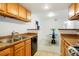 Updated kitchen flowing into the dining area, featuring granite counters and stainless steel appliances at 3452 S Eagle St # 101, Aurora, CO 80014