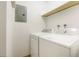 Laundry room featuring a washer and dryer with overhead storage at 3452 S Eagle St # 101, Aurora, CO 80014