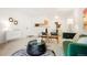 Open living space with neutral walls, stylish decor, and seamless flow into dining and kitchen areas at 3452 S Eagle St # 101, Aurora, CO 80014
