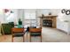 Cozy living room with a stone fireplace, comfortable seating, and natural light from the sliding glass doors at 3452 S Eagle St # 101, Aurora, CO 80014