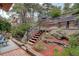 Landscaped backyard with multiple levels and a charming waterfall feature, creating a serene outdoor oasis at 34127 Cactus Dr, Evergreen, CO 80439