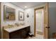 Elegant bathroom with a double sink vanity, framed mirrors, and an open doorway to a modern walk-in shower at 34127 Cactus Dr, Evergreen, CO 80439
