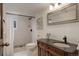 Updated bathroom featuring a walk-in shower, modern fixtures, and a classic vanity at 34127 Cactus Dr, Evergreen, CO 80439