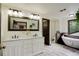 Bright bathroom with dual vanity, soaking tub, and elegant wood accents at 34127 Cactus Dr, Evergreen, CO 80439