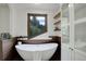Bright bathroom featuring a soaking tub, a glass shower, and natural wood elements at 34127 Cactus Dr, Evergreen, CO 80439