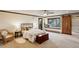 Cozy bedroom boasts natural light, a window seat, and stylish sliding barn door at 34127 Cactus Dr, Evergreen, CO 80439