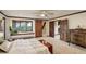 Spacious bedroom featuring a window seat, sliding barn door and stairway entrance at 34127 Cactus Dr, Evergreen, CO 80439