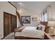 Cozy bedroom featuring vaulted ceiling, ladder to loft, and a window overlooking the outdoors at 34127 Cactus Dr, Evergreen, CO 80439