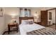 Comfortable bedroom with a woven headboard, plush bedding, and decorative pillows at 34127 Cactus Dr, Evergreen, CO 80439