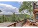 Deck showcasing mountain views, a table with seating, and a serene outdoor space for relaxation and entertainment at 34127 Cactus Dr, Evergreen, CO 80439