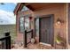 Inviting home entrance featuring a charming front door, stone accents, and mountain views at 34127 Cactus Dr, Evergreen, CO 80439