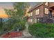 Charming home featuring stone accents, wood siding, and a beautiful, landscaped front yard at 34127 Cactus Dr, Evergreen, CO 80439