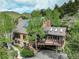 Charming multi-level home with stone accents, a deck, and nestled amongst lush trees at 34127 Cactus Dr, Evergreen, CO 80439