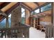 Bright home office features exposed beam ceilings, built-in shelving, and mountain views at 34127 Cactus Dr, Evergreen, CO 80439