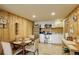 Efficient kitchen featuring modern appliances, white cabinets, wood walls, and an adjacent dining area with a wooden table at 34127 Cactus Dr, Evergreen, CO 80439